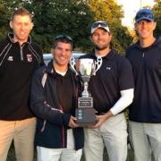4 wcs employees holding golf trophy