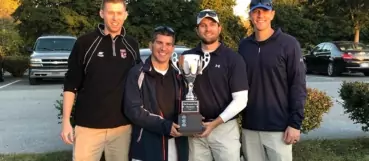 4 wcs employees holding golf trophy