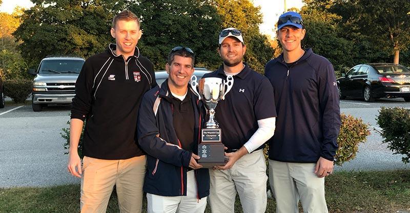 4 wcs employees holding golf trophy