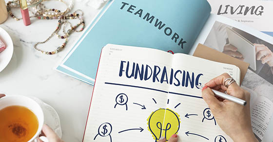Notebook illustrating a nonprofit fundraising strategy with financial planning concepts for sustainable fundraising success.