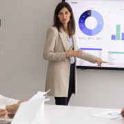 Woman business professional reviewing financial reports during a board presentation with an accounting firm in Howard County.