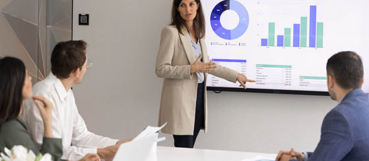 Woman business professional reviewing financial reports during a board presentation with an accounting firm in Howard County.