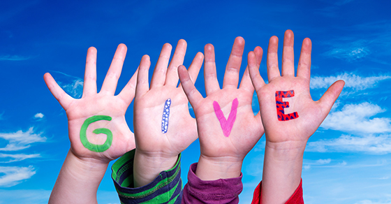 Children raising their hands to spell "GIVE," representing charitable giving and nonprofit support with guidance from WCS CPA a CPA firm in Baltimore.