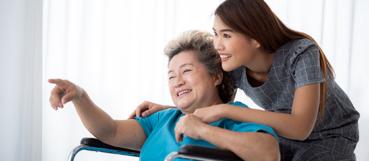 Woman caring for an older family member during paid leave, with tax planning in Baltimore County from WCS.