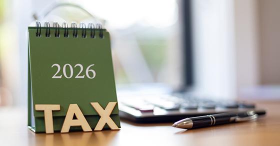 Green 2026 tax desk calendar next to a calculator and pen, representing year-end tax planning from Weyrich, Cronin & Sorra